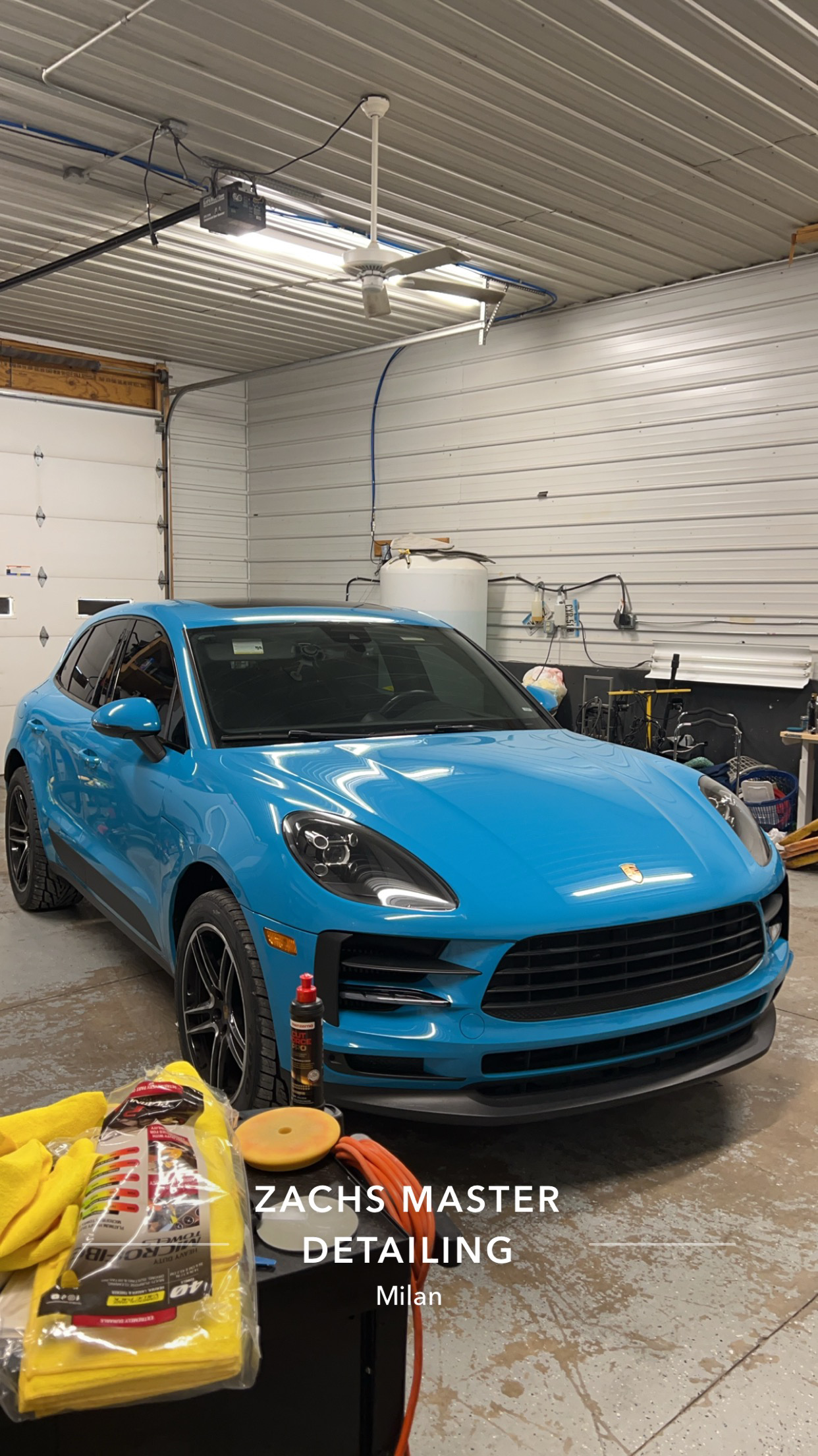 Blue Porsche Macan inside detailing garage
